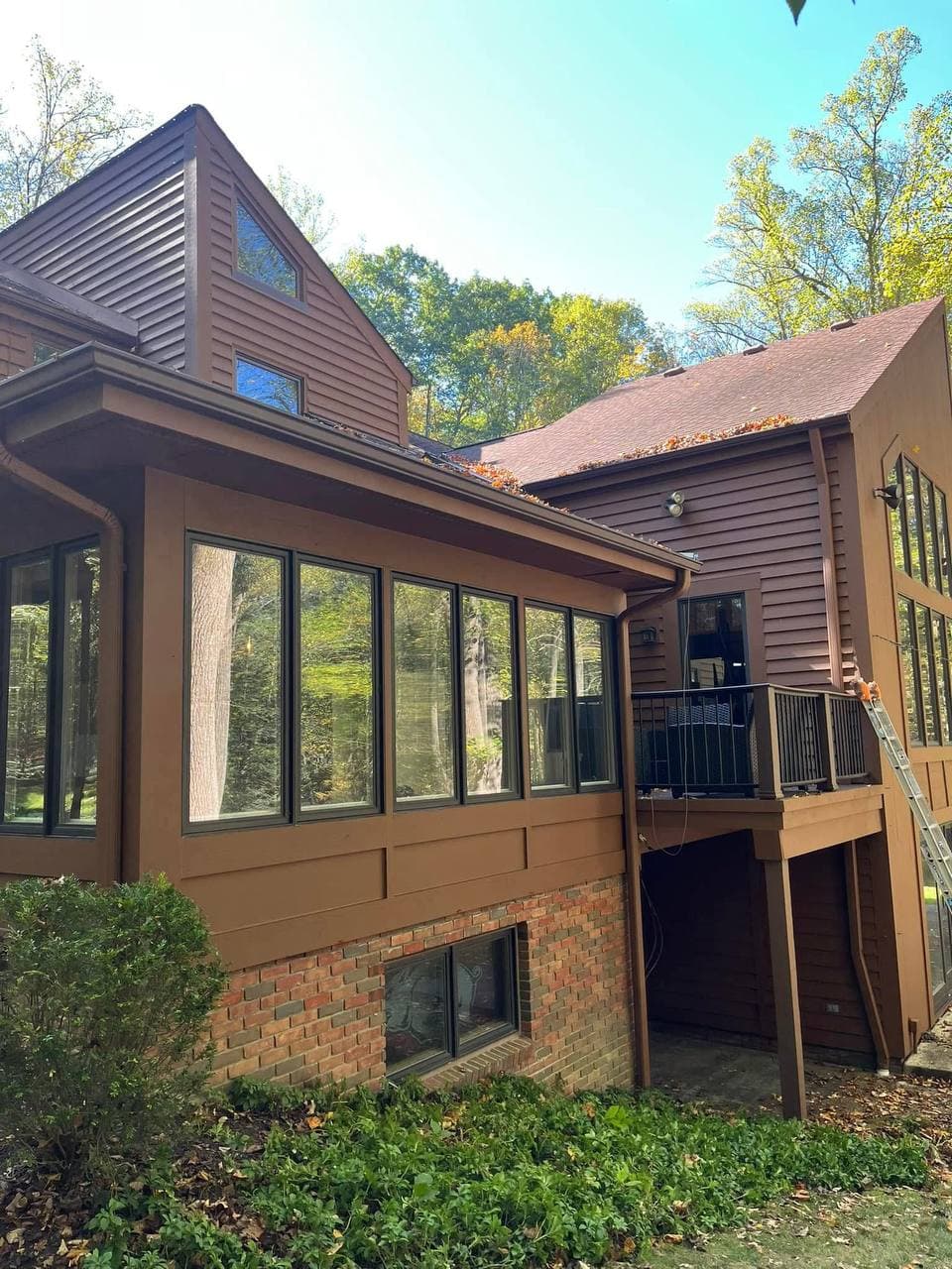 House exterior after repainting, brown siding